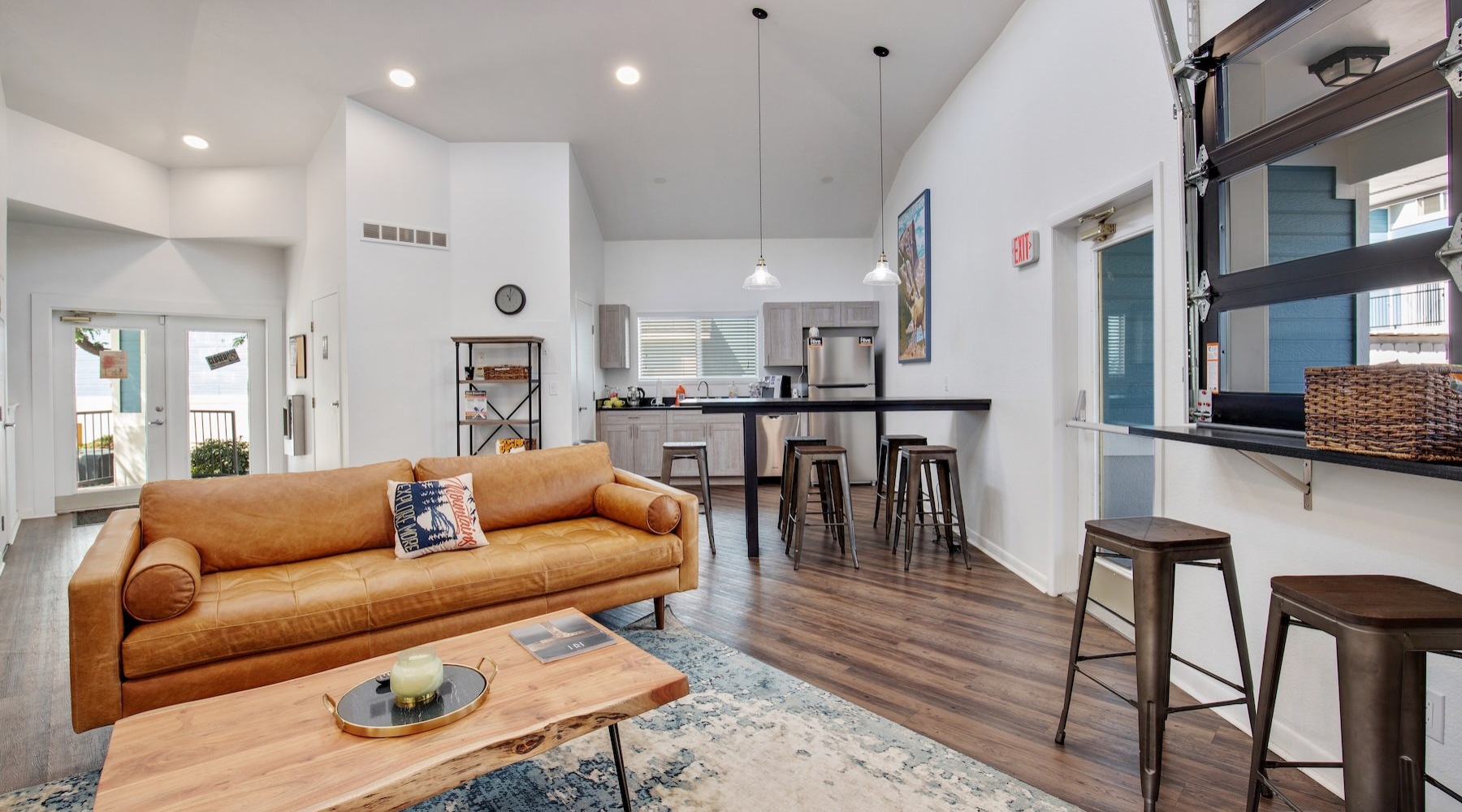 a clubroom with a couch, tables and chairs
