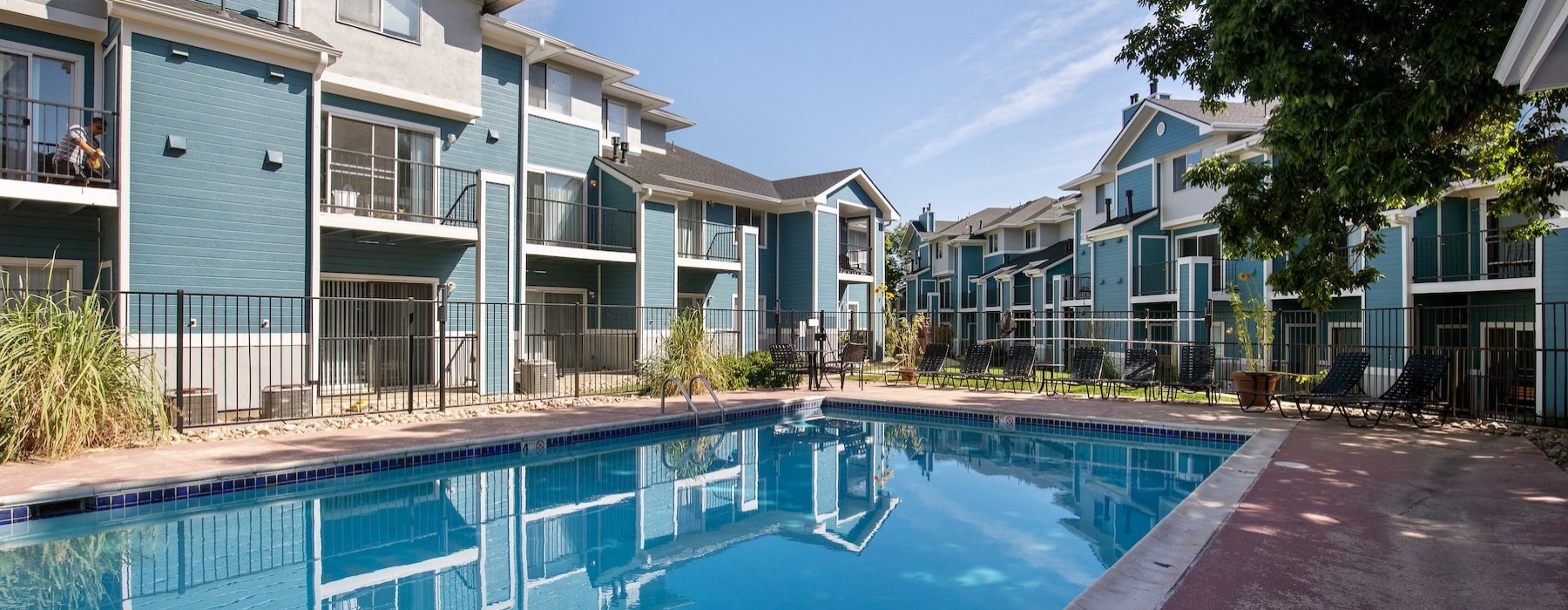 a swimming pool in front of a row of houses