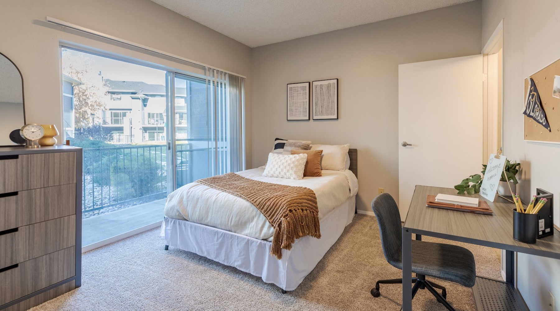 a bedroom with a bed, desk and a chair